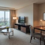 Modern corporate housing DC apartment featuring a furnished living room, work desk, and city view, ideal for short-term business and professional stays.