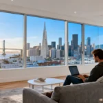 Vacation Rentals in the San Francisco Area with skyline view and person working on laptop